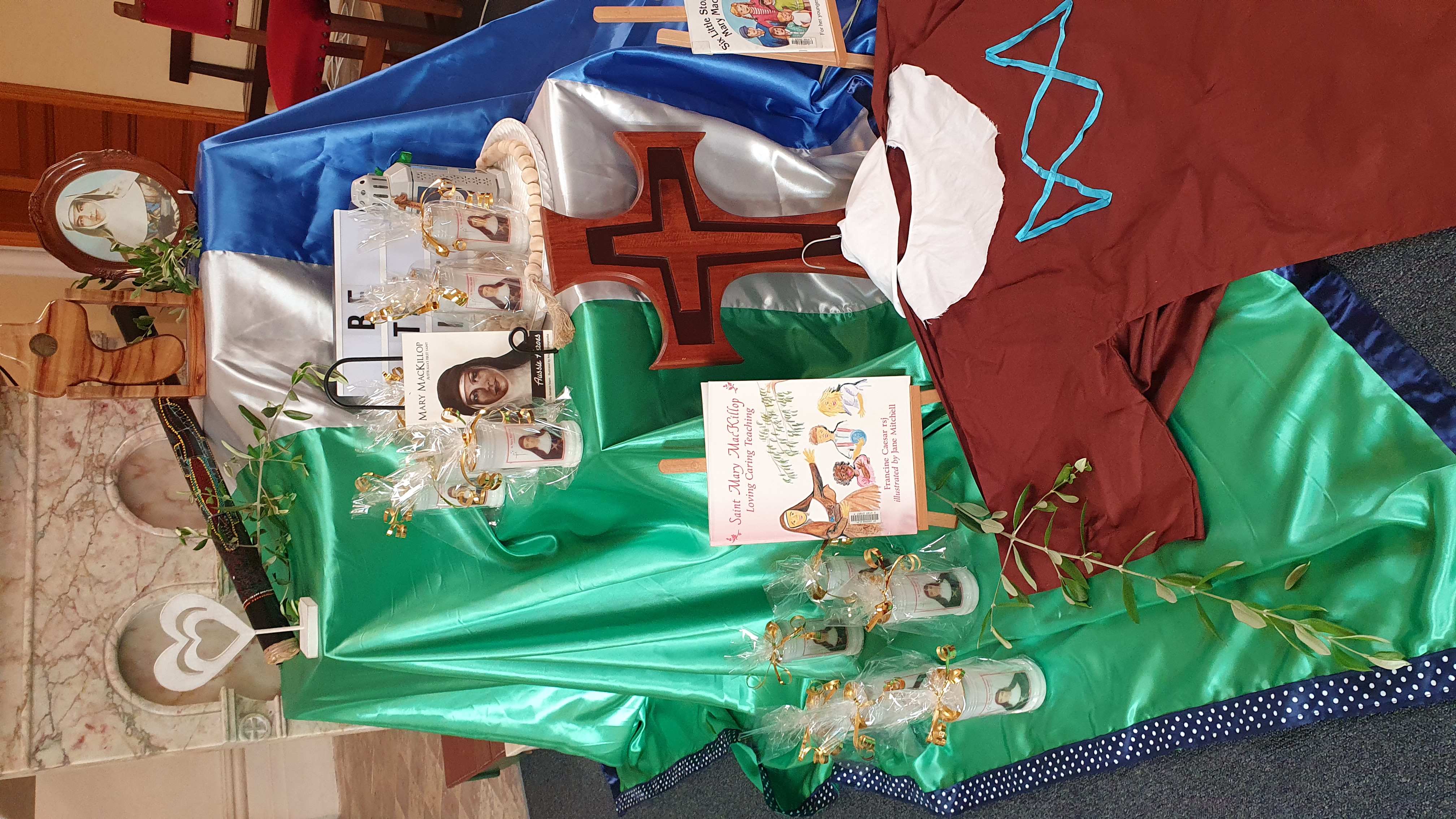 Mary MacKillop prayer and reflection display featuring faith symbols books and imagery, highlighting the Josephite charism and commitment to mercy service and Catholic identity within the school community