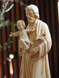 Statue of Saint Joseph holding the child Jesus, representing care, guidance, faith and the spiritual foundations of the school community